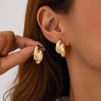 Double Twist Dome Huggie Hoops — Gold